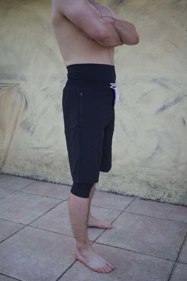 Side profile of a white muslim man wearing a halal swimming short